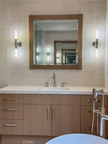 a bathroom with a tub sink and mirror