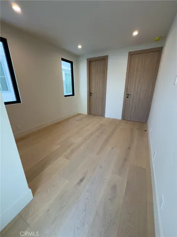 a spacious bedroom with a bed and window