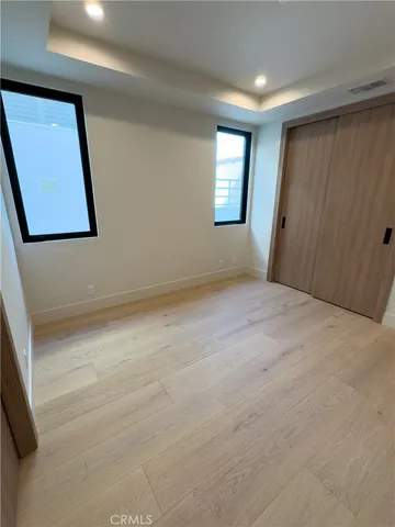 a view of large kitchen with granite countertop a sink and cabinets