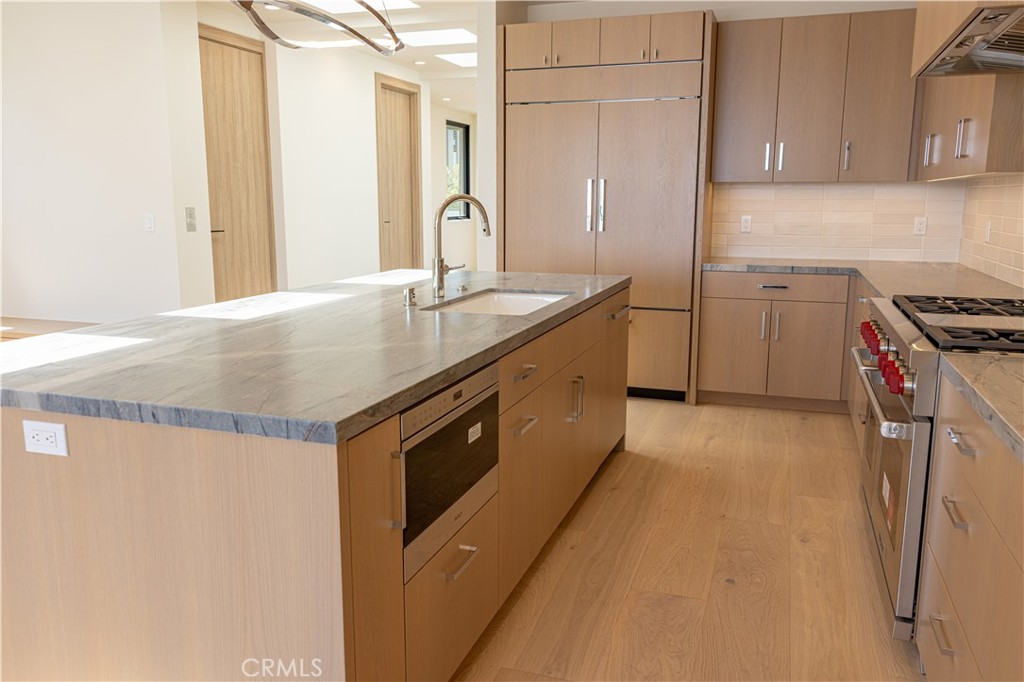 404 16th Street Manhattan Beach, CA 90266 - Photo 29 of 58 a kitchen with stainless steel appliances granite countertop a sink stove and refrigerator