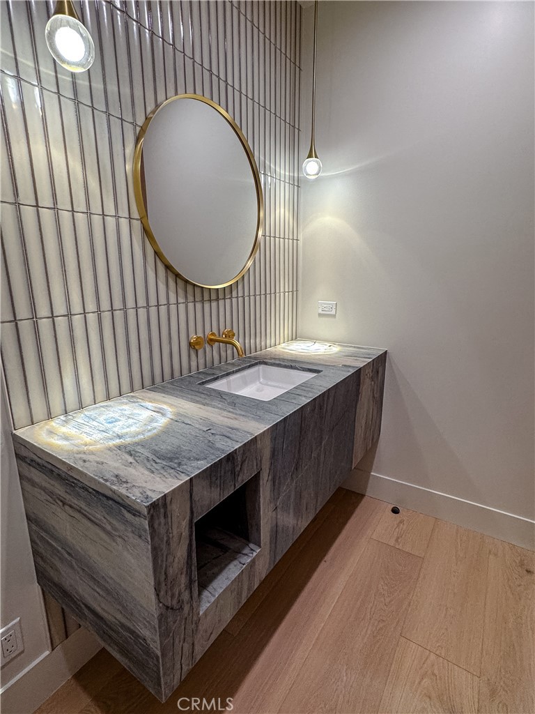 404 16th Street Manhattan Beach, CA 90266 - Photo 39 of 58 a spacious bathroom with a granite countertop sink and a mirror