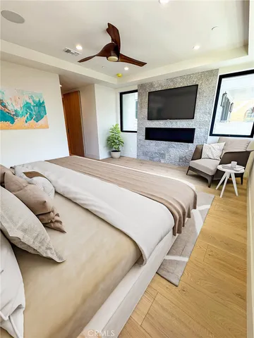 a bedroom with a bed and a large window