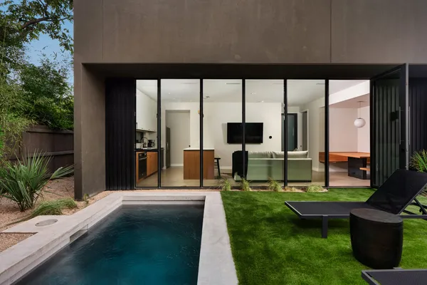 a view of a house with backyard porch and sitting area