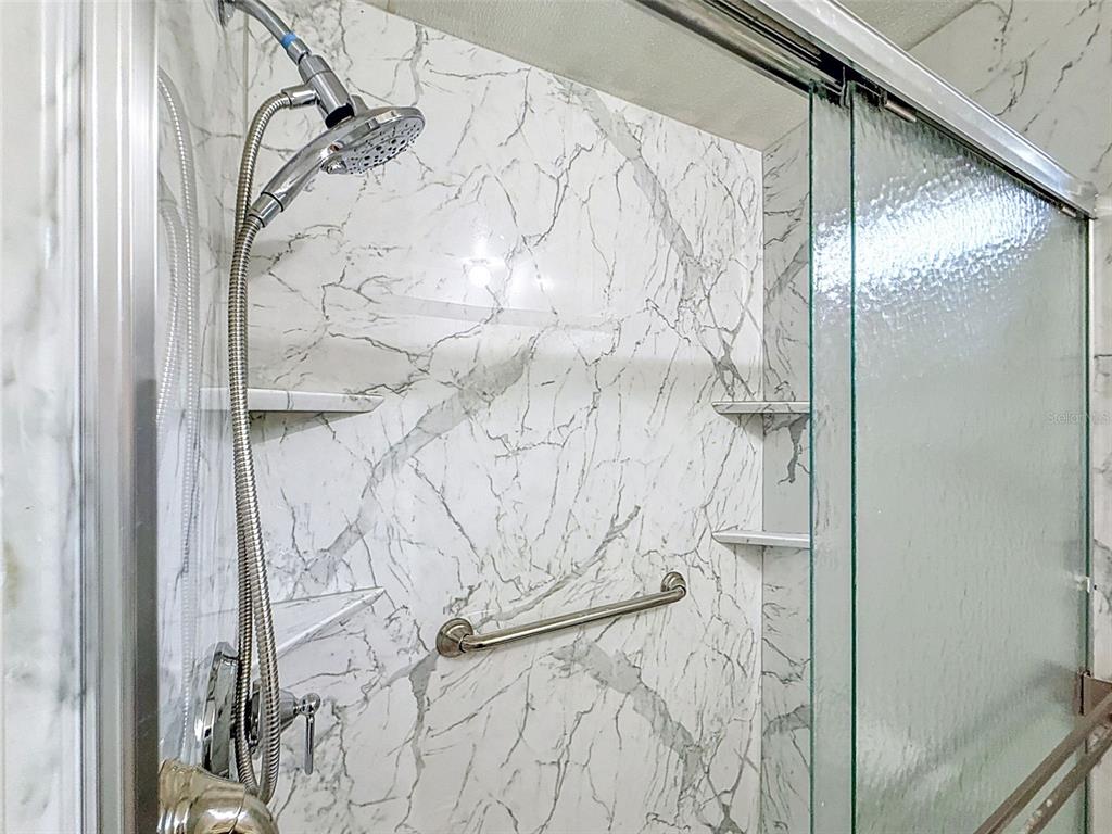 1819 Sinclair Hills Road Lutz, FL 33549 - Photo 45 of 60 a bathroom with a bathtub and shower