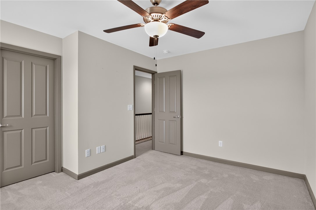 235 Pendleton Road, Unit K1 Clemson, SC 29631 - Photo 30 of 49 A well-lit bedroom features plush carpeting and a modern ceiling fan, providing comfort and style.