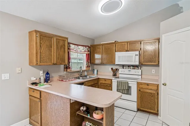 a kitchen with a stove a sink and a refrigerator