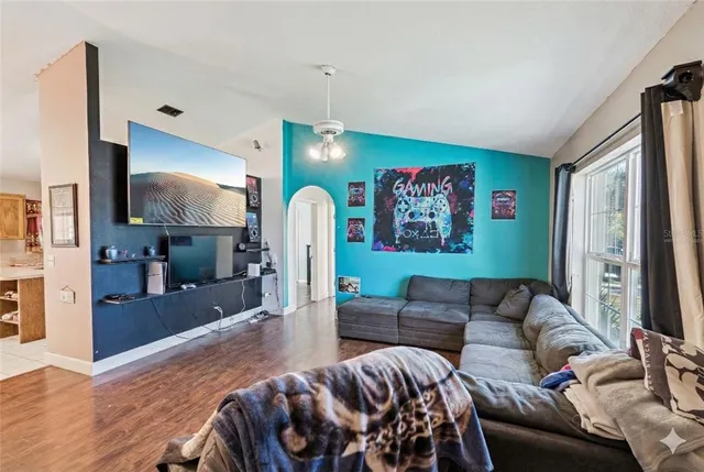 a living room with furniture and a flat screen tv