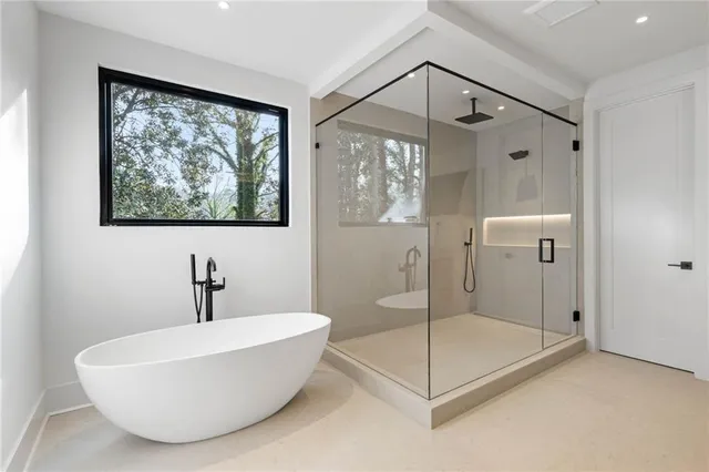 a bathroom with a tub and a shower