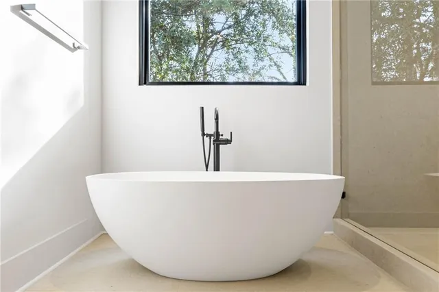 a white tub sitting next to a window