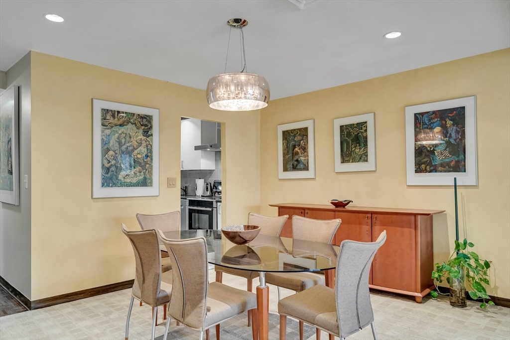 405 Langley Road, Unit 6 Newton, MA 02459 - Photo 11 of 42 a view of a dining room with furniture and a chandelier