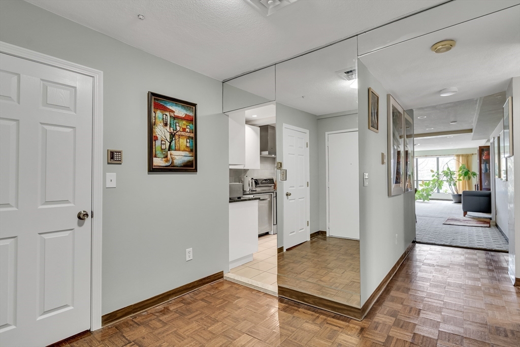 405 Langley Road, Unit 6 Newton, MA 02459 - Photo 15 of 42 a view of a hallway view with wooden floor and living room