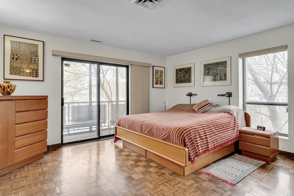 405 Langley Road, Unit 6 Newton, MA 02459 - Photo 17 of 42 a bedroom with a bed and a large window