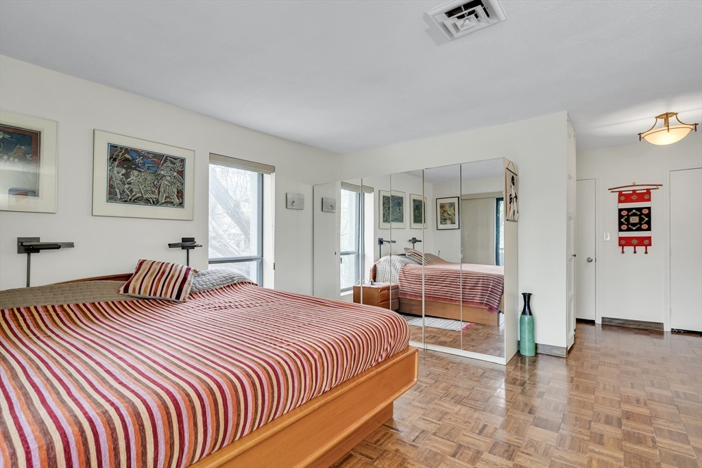 405 Langley Road, Unit 6 Newton, MA 02459 - Photo 18 of 42 a bedroom with a large bed and a couch