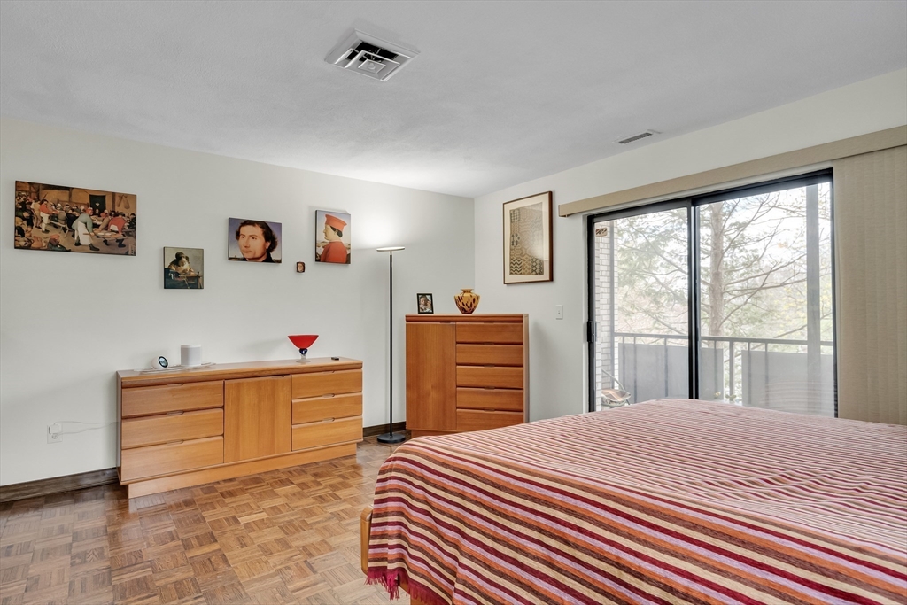 405 Langley Road, Unit 6 Newton, MA 02459 - Photo 19 of 42 a bedroom with a bed and a dresser