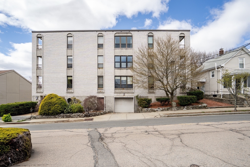 405 Langley Road, Unit 6 Newton, MA 02459 - Photo 2 of 42 a front view of a building with street view