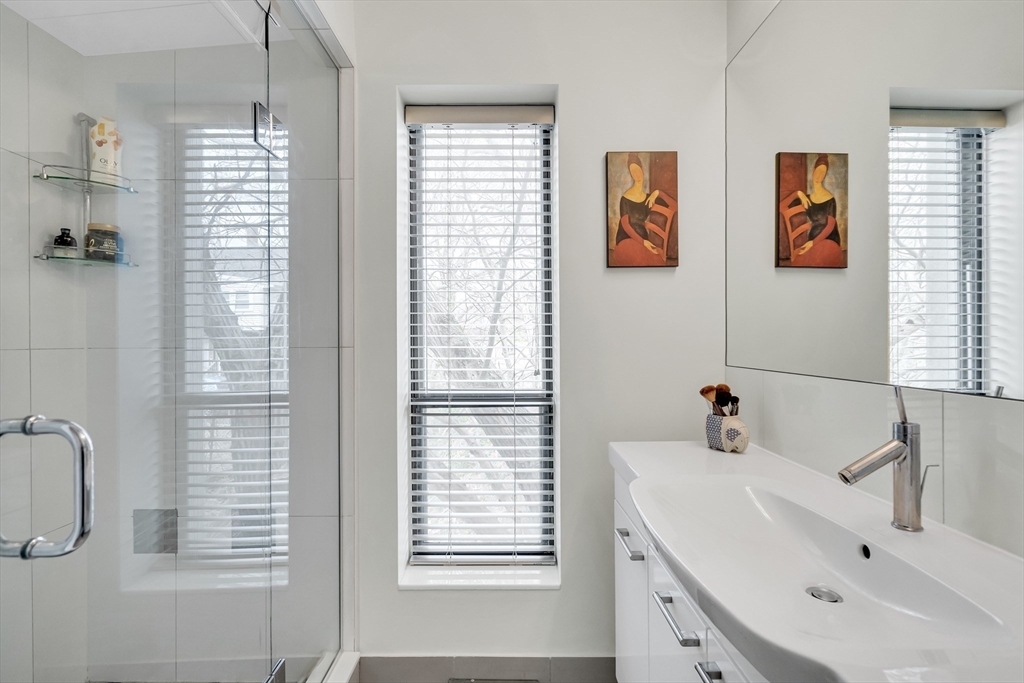405 Langley Road, Unit 6 Newton, MA 02459 - Photo 23 of 42 a bathroom with a sink a shower and a window