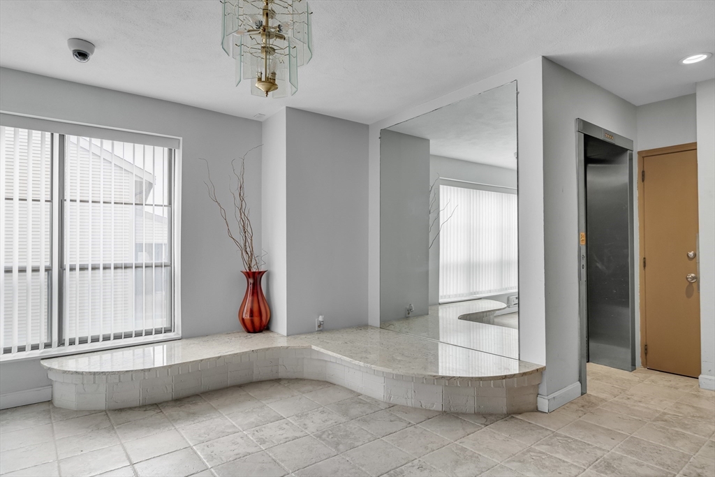 405 Langley Road, Unit 6 Newton, MA 02459 - Photo 3 of 42 a bathroom with a tub and shower