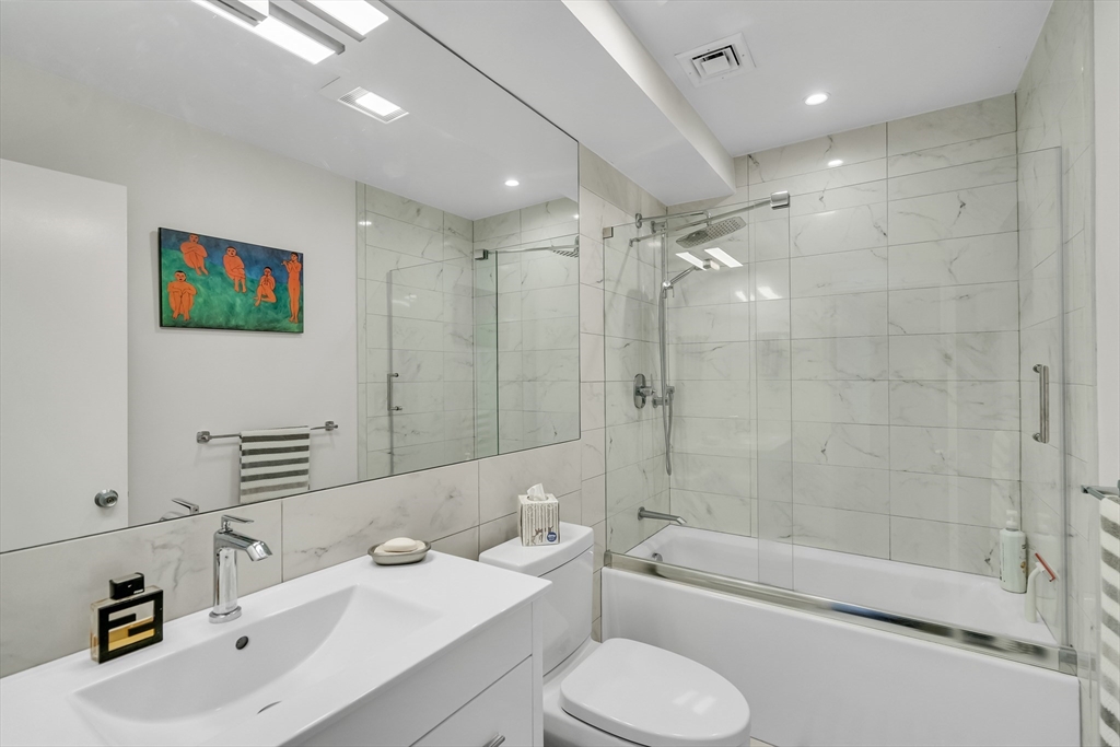 405 Langley Road, Unit 6 Newton, MA 02459 - Photo 35 of 42 a bathroom with a sink a toilet and shower