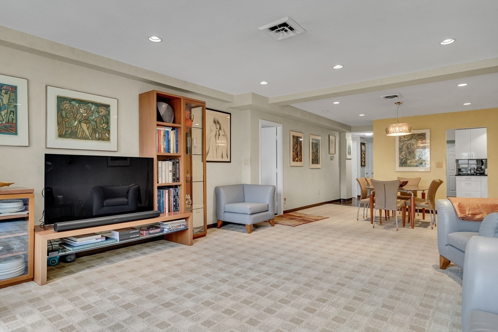 405 Langley Road, Unit 6 Newton, MA 02459 - Photo 6 of 42 a living room with furniture and a flat screen tv