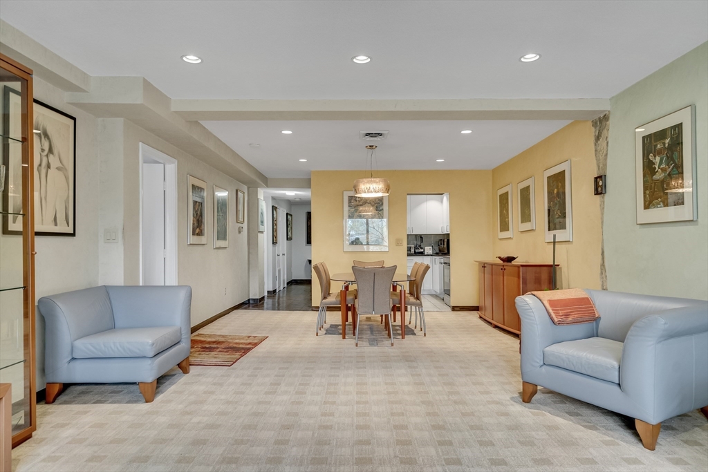 405 Langley Road, Unit 6 Newton, MA 02459 - Photo 7 of 42 a living room with furniture kitchen view and a wooden floor