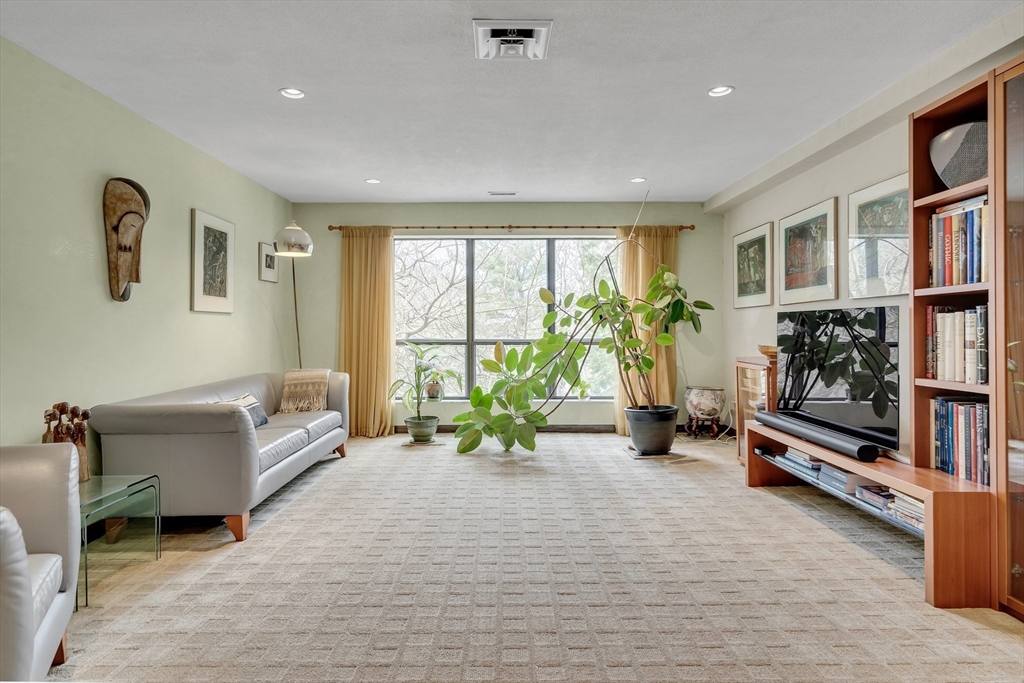 405 Langley Road, Unit 6 Newton, MA 02459 - Photo 9 of 42 a living room with furniture and a flat screen tv