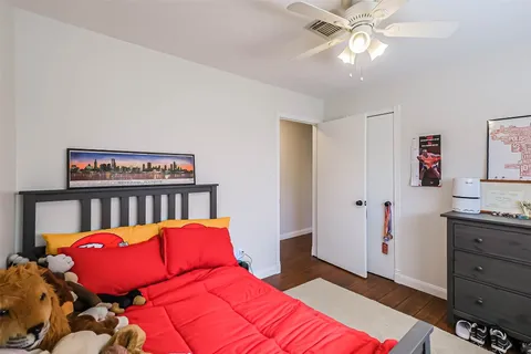 a bedroom with a bed and a chandelier