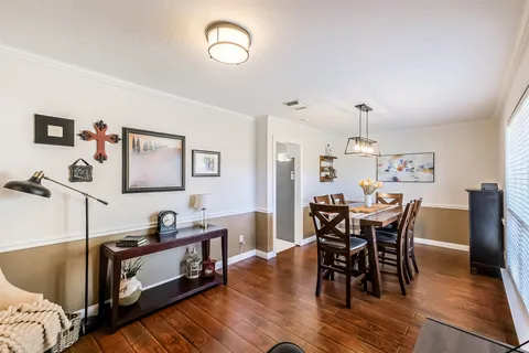 a view of a dining room with furniture and wooden floor