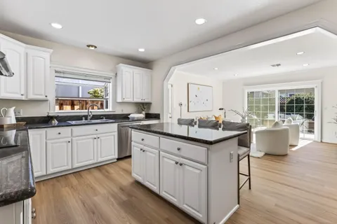 a kitchen with sink stove and cabinets
