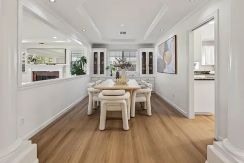a dining room with furniture and wooden floor