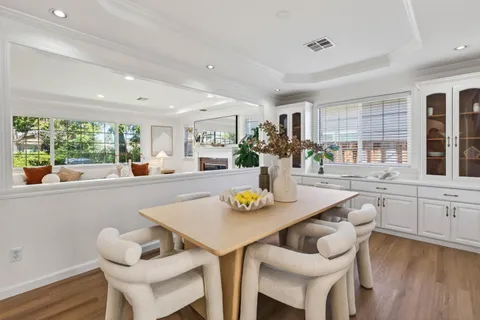 a dining room with furniture and window