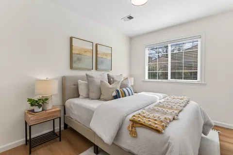 a bedroom with bed and a window