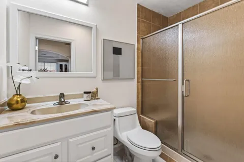 a bathroom with a sink toilet and shower