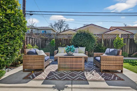 a view of a patio with a table and chairs