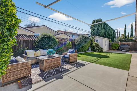a view of a backyard with sitting area
