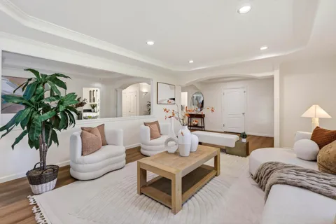 a living room with furniture potted plant and a window