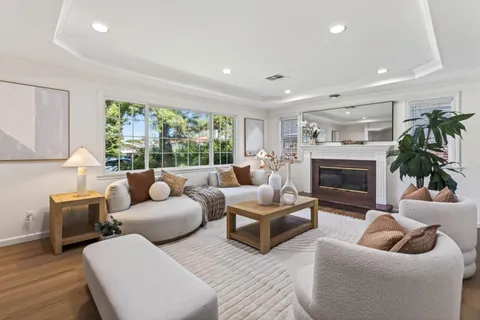 a living room with furniture and a fireplace