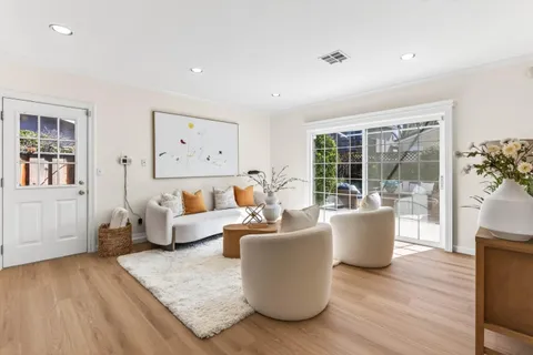 a living room with furniture and large windows