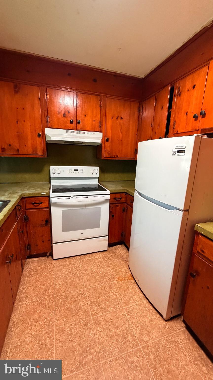 711 Rigby Avenue Cambridge, MD 21613 - Photo 8 of 21 Cozy kitchen with warm wood accents.