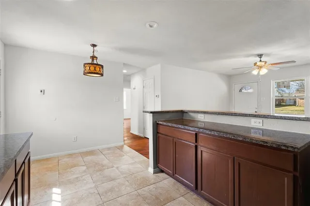 a spacious bathroom with a granite countertop sink and a mirror
