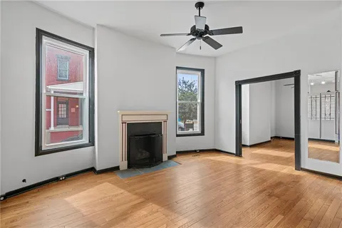 a view of a room with wooden floor