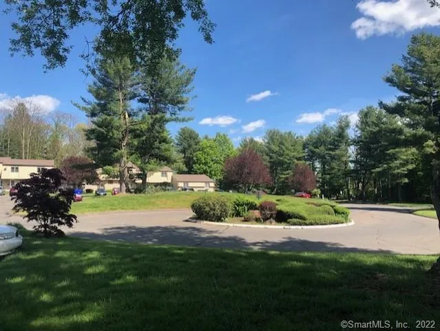 a view of a garden with a house in the background