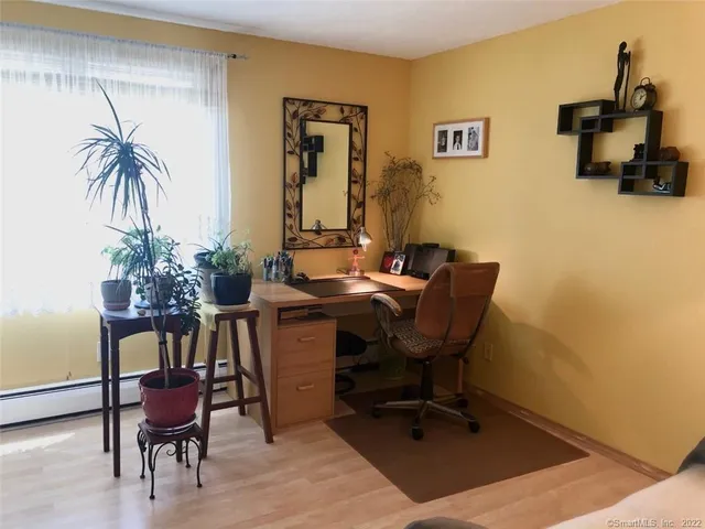 a view of a workspace with furniture and a potted plant