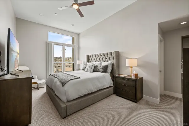 a bedroom with a bed couch and window