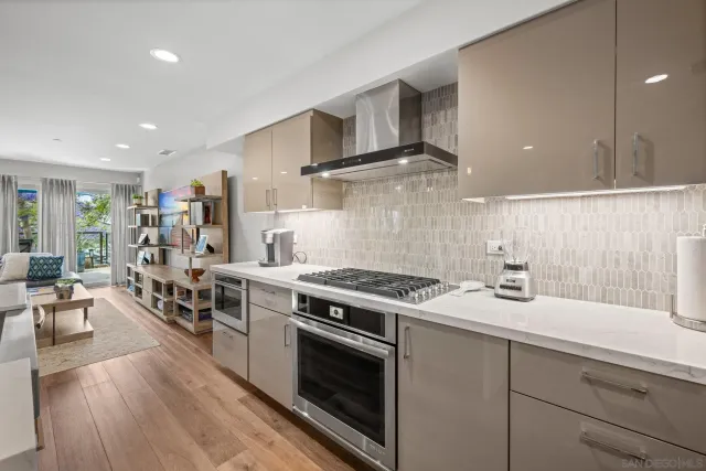 a kitchen with a stove cabinets and wooden floor