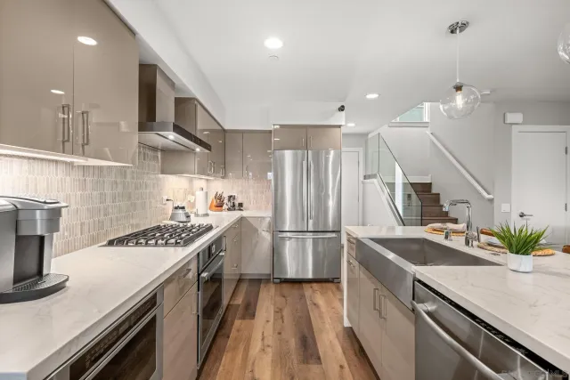 a kitchen with kitchen island a counter space a stove and a refrigerator