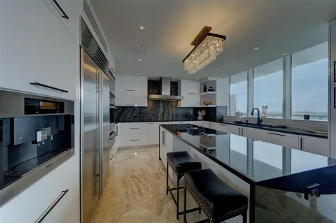 a large kitchen with kitchen island a large island in the center