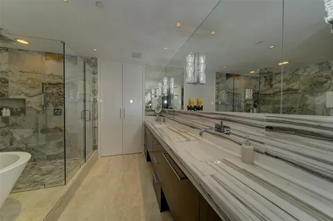 a bathroom with a double vanity sink and mirror