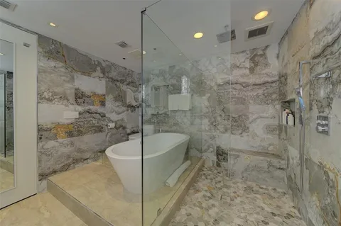 a bathroom with a bathtub and shower