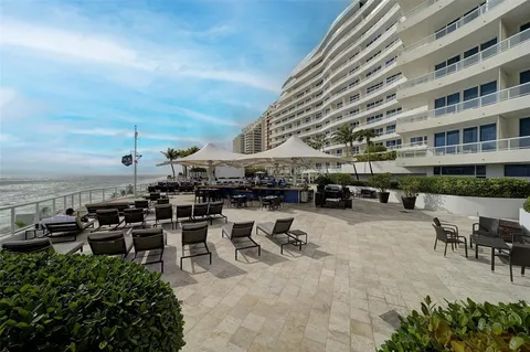 a view of a patio with table and chairs potted plants