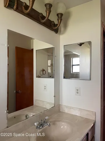 a kitchen with stainless steel appliances a sink a stove a refrigerator and cabinets